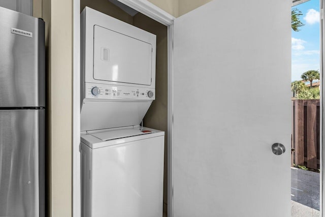 laundry room with stacked washer / dryer