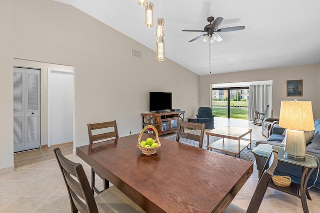 dining area with high vaulted ceiling, light tile flooring, and ceiling fan