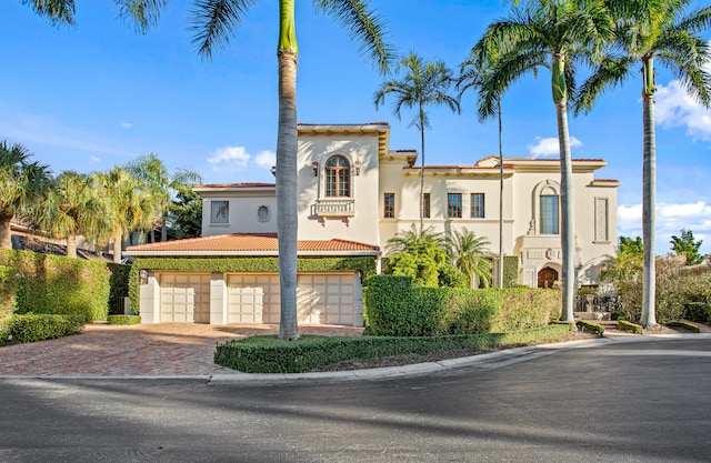 mediterranean / spanish house with a garage