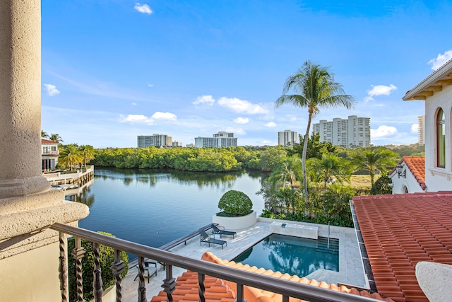 view of swimming pool with a hot tub and a water view