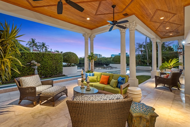 patio terrace at dusk featuring an outdoor hangout area and ceiling fan