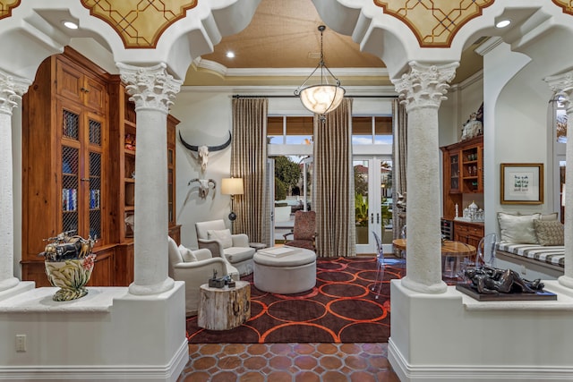 tiled living room with crown molding and ornate columns