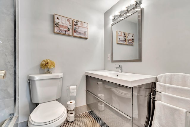 bathroom with tile patterned floors, vanity, walk in shower, and toilet