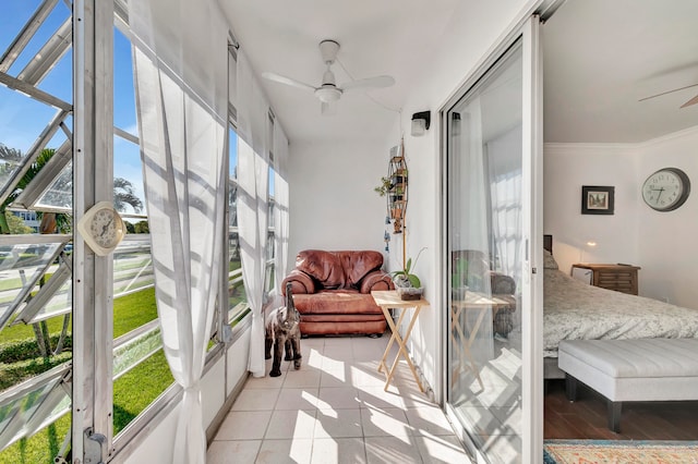 sunroom / solarium featuring ceiling fan