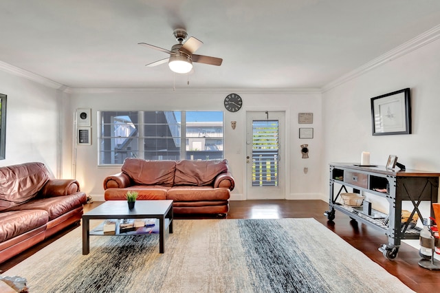 living room with dark wood-type flooring, ceiling fan, and crown molding