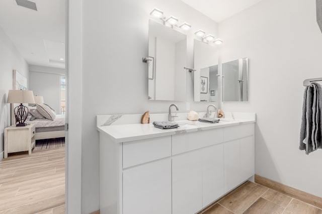 bathroom featuring hardwood / wood-style floors and dual vanity