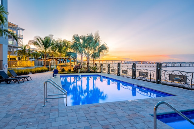 view of pool at dusk