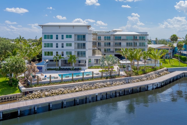 exterior space with a water view and a community pool