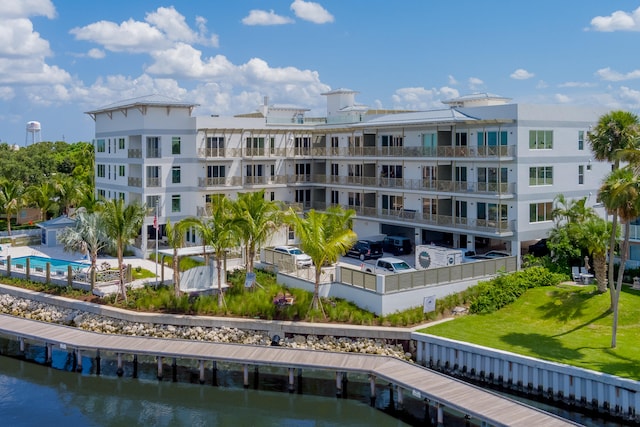 exterior space with a water view and a community pool