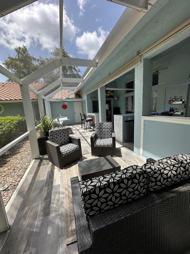 view of patio / terrace with a lanai, ceiling fan, and an outdoor hangout area