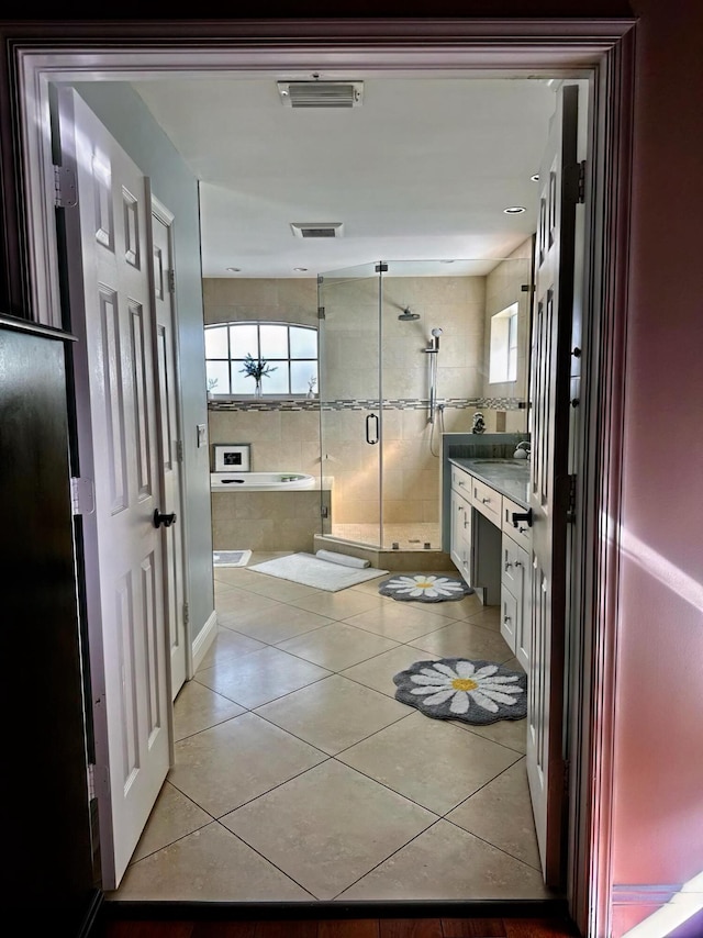 bathroom featuring vanity, tile patterned flooring, and a shower with shower door