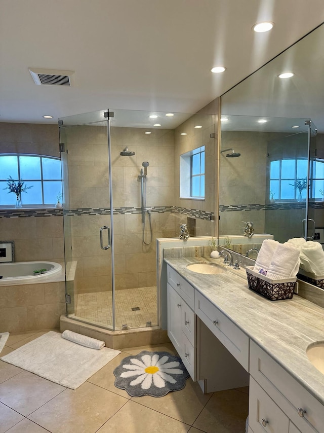 bathroom featuring vanity, independent shower and bath, and tile patterned flooring