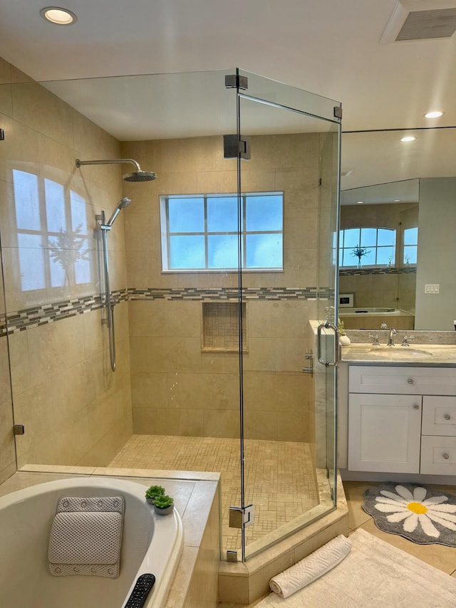 bathroom featuring vanity, tile patterned flooring, and separate shower and tub