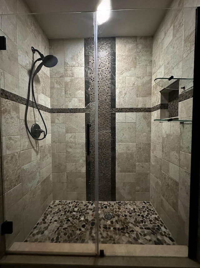 bathroom with a shower with door