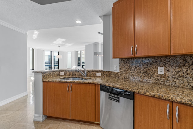 kitchen featuring a textured ceiling, ornamental molding, dark stone counters, and stainless steel dishwasher