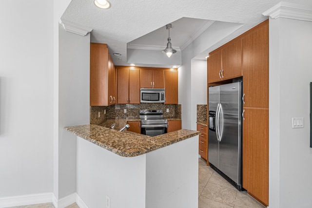 kitchen with light tile floors, dark stone counters, appliances with stainless steel finishes, tasteful backsplash, and decorative light fixtures