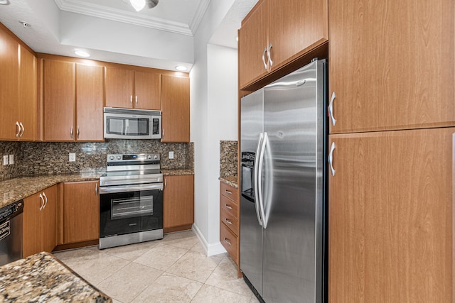 kitchen featuring tasteful backsplash, stainless steel appliances, dark stone countertops, and ornamental molding