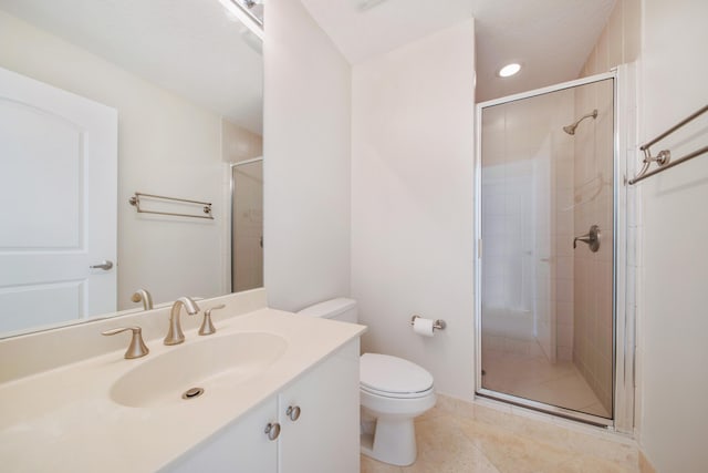 bathroom featuring vanity, tile flooring, a shower with door, and toilet