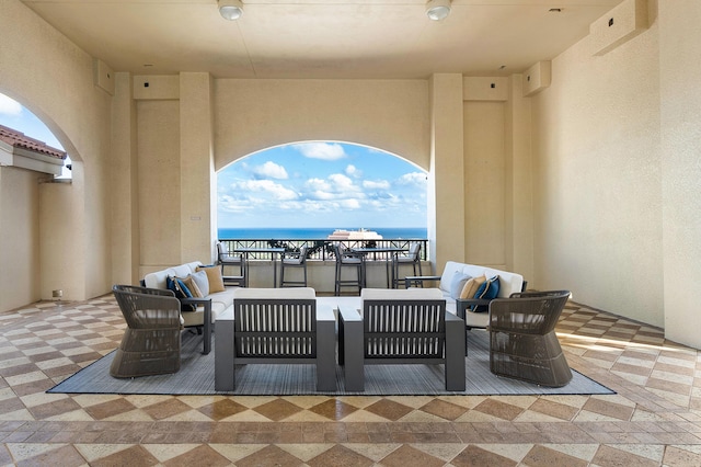 view of terrace featuring outdoor lounge area and a water view