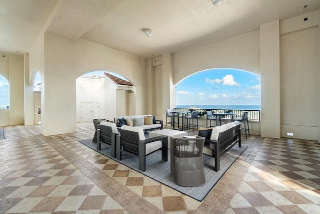 view of terrace featuring a water view and an outdoor living space