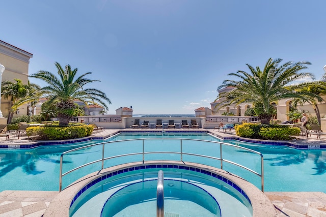 view of swimming pool featuring a hot tub