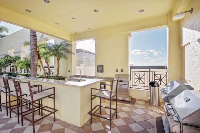 view of terrace with a wet bar and exterior kitchen