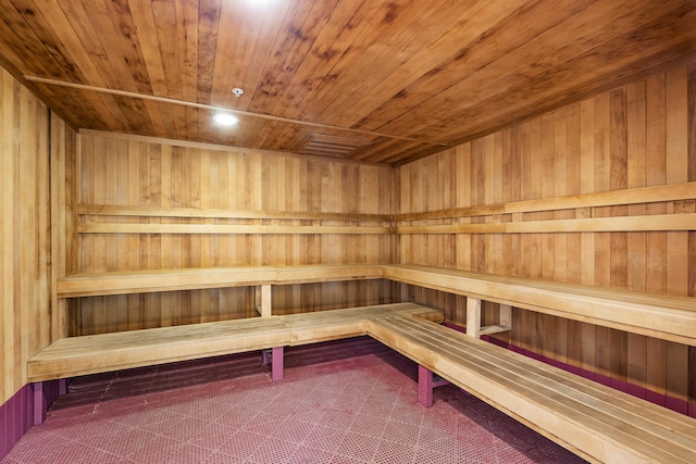 view of sauna featuring tile floors, wooden walls, and wooden ceiling