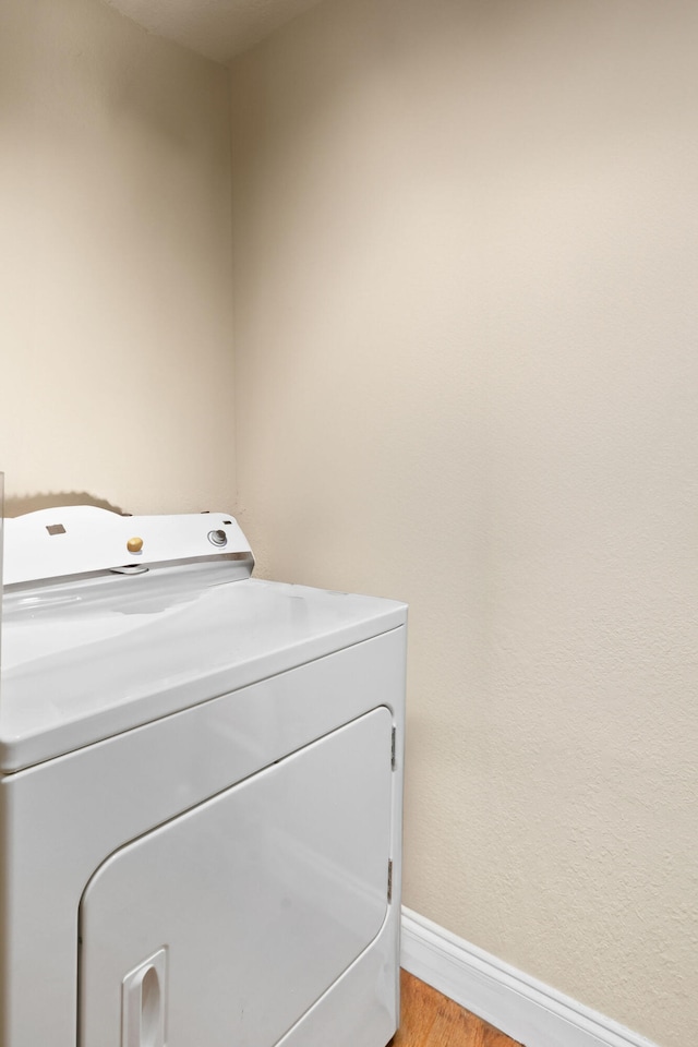 laundry area with light hardwood / wood-style floors and washer / clothes dryer