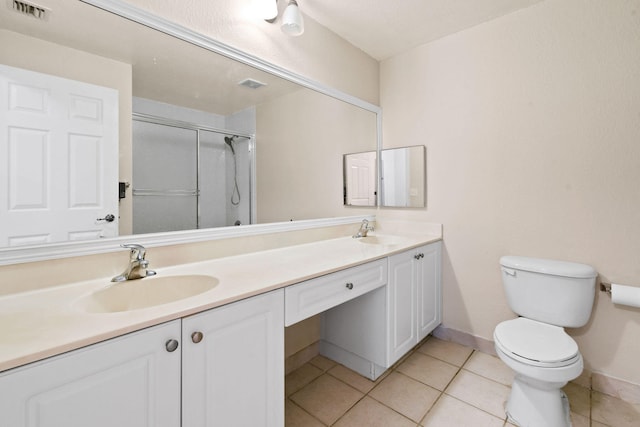 bathroom featuring toilet, double sink vanity, and tile flooring