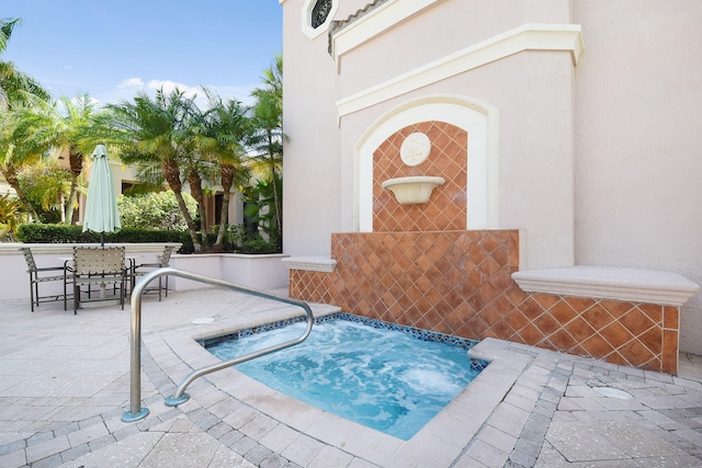 view of swimming pool with an in ground hot tub and a patio