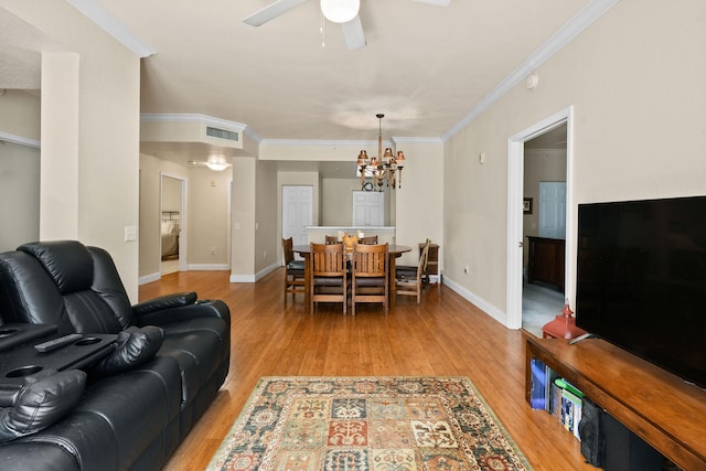 living room featuring crown molding, ceiling fan with notable chandelier, and light hardwood / wood-style flooring