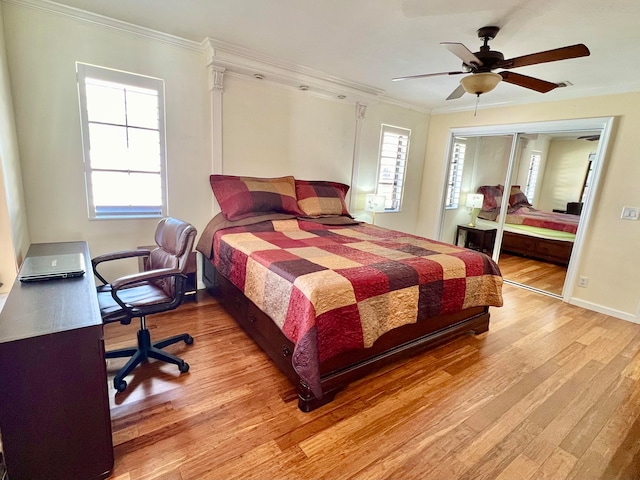 bedroom with ceiling fan, a closet, light hardwood / wood-style floors, and ornamental molding