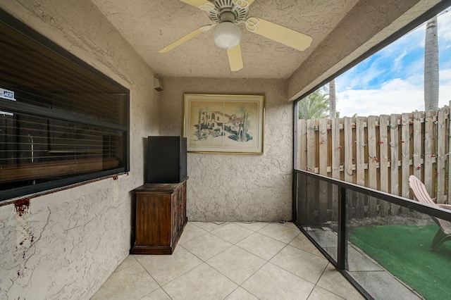 sunroom / solarium featuring ceiling fan