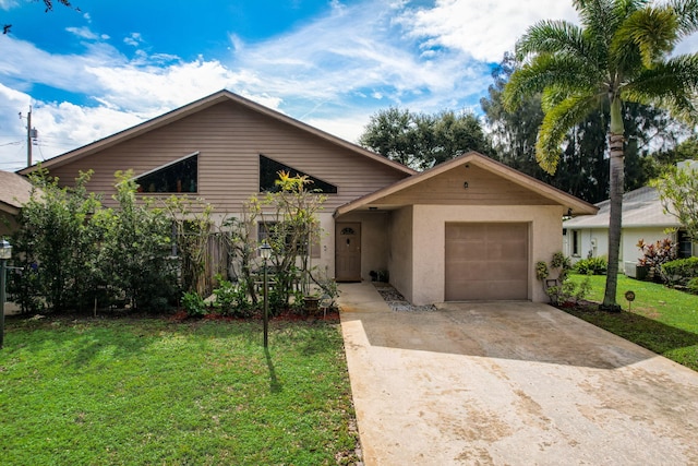 single story home featuring a garage and a front lawn