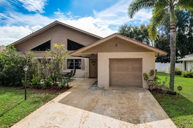 view of front of house featuring a garage and a front lawn