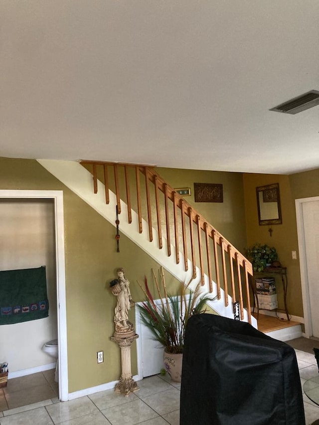 staircase with light tile flooring