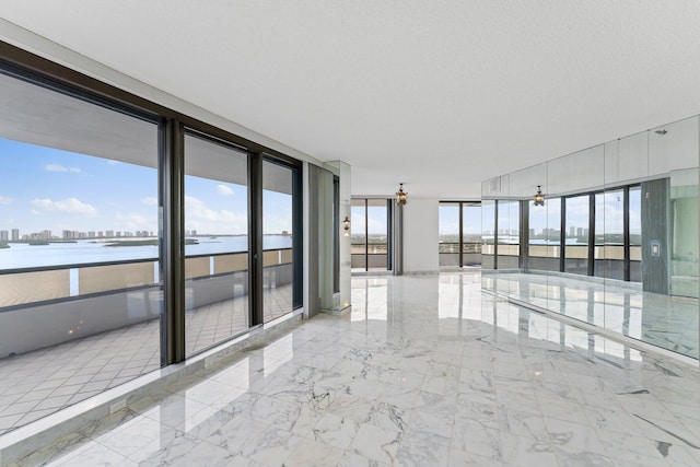 empty room with floor to ceiling windows and a water view