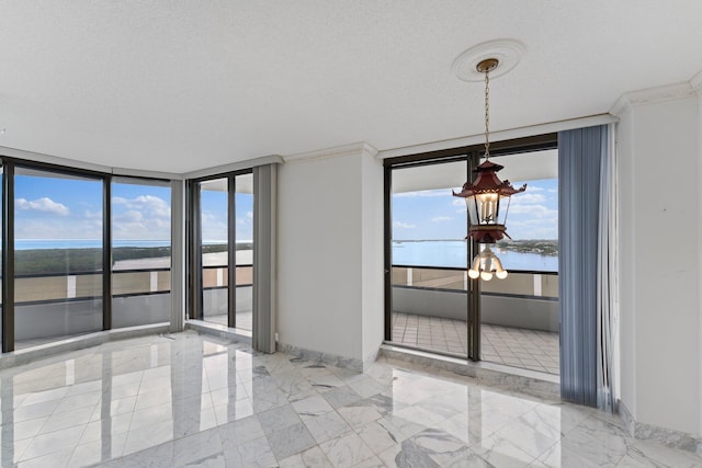 unfurnished dining area featuring a wall of windows, a water view, crown molding, and a textured ceiling