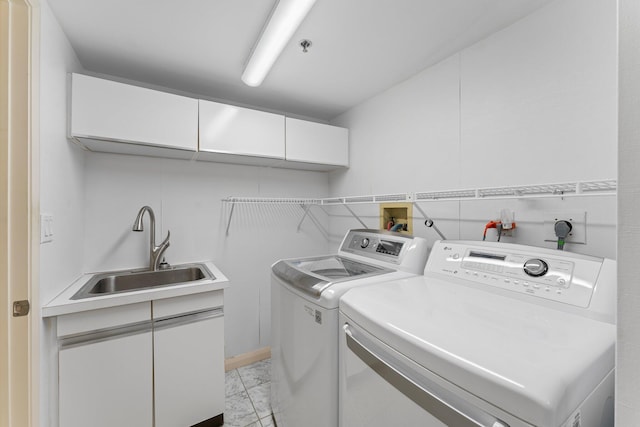 laundry area with independent washer and dryer and sink