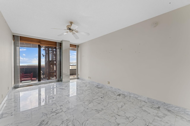 spare room with ceiling fan and a textured ceiling