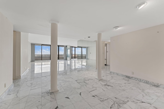 unfurnished room featuring decorative columns