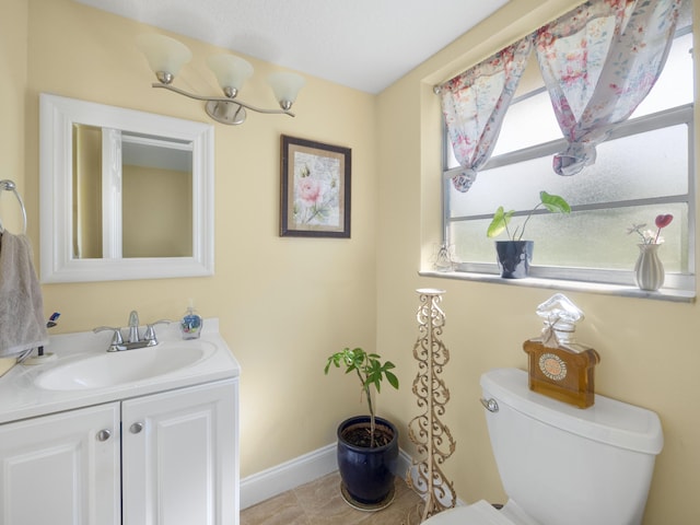 bathroom featuring vanity, toilet, and tile floors