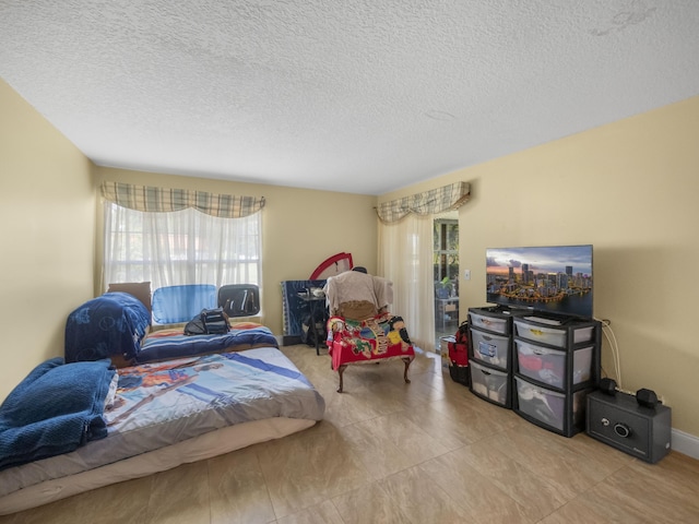 bedroom featuring a textured ceiling and tile floors