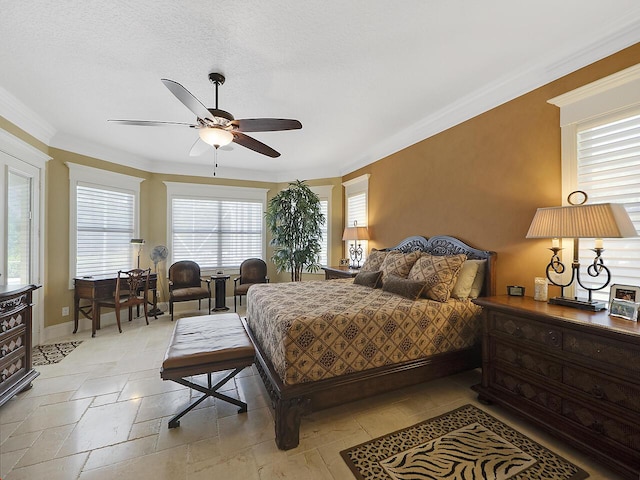 bedroom with crown molding, stone tile floors, a ceiling fan, and baseboards