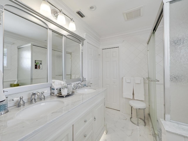 full bath featuring ornamental molding, visible vents, and a sink