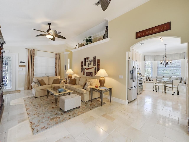 living area featuring baseboards, lofted ceiling, ornamental molding, ceiling fan with notable chandelier, and arched walkways