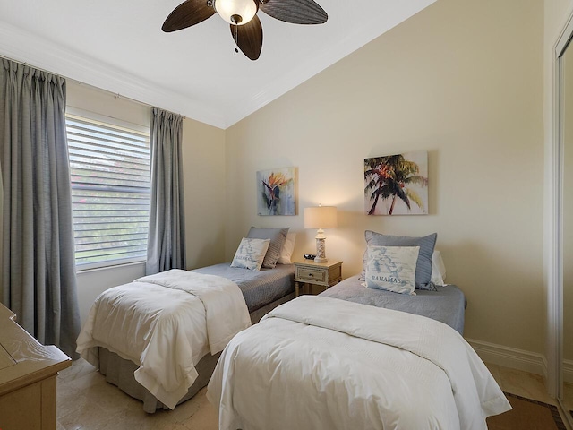 bedroom featuring ceiling fan, baseboards, and lofted ceiling