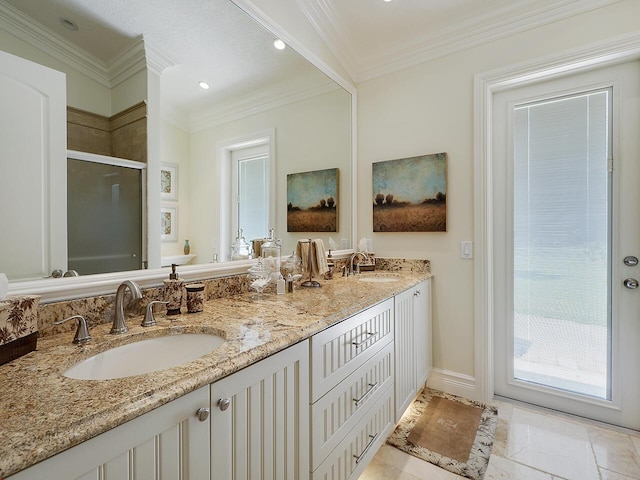 full bath with double vanity, ornamental molding, a stall shower, and a sink