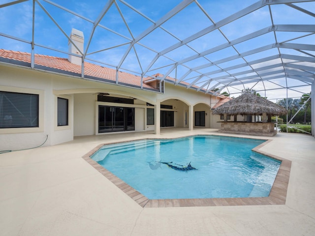 pool featuring a patio, a lanai, and a ceiling fan