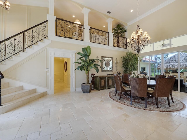 dining room featuring stairway, stone tile floors, visible vents, decorative columns, and crown molding